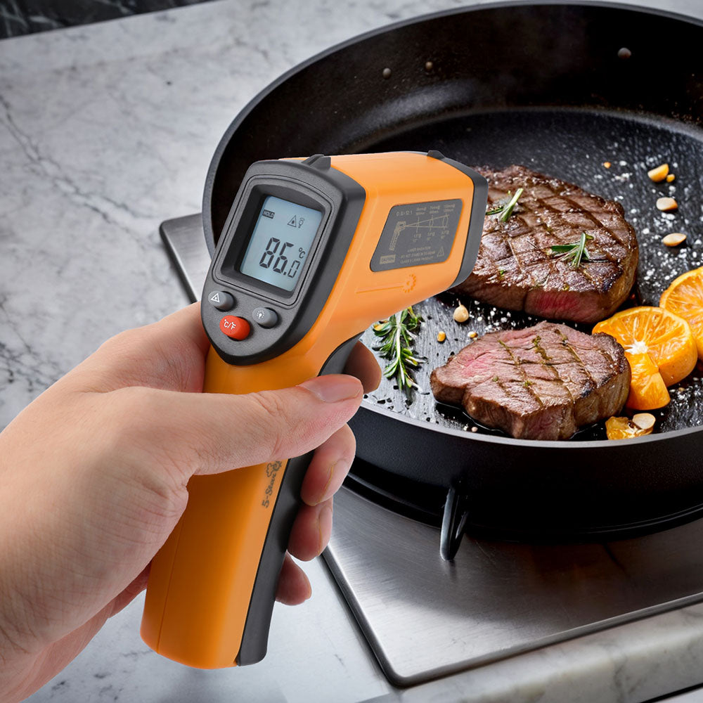 Digital thermometer displaying 86.0°F while measuring meat temperature, featuring an ergonomic orange handle and backlit LCD screen.