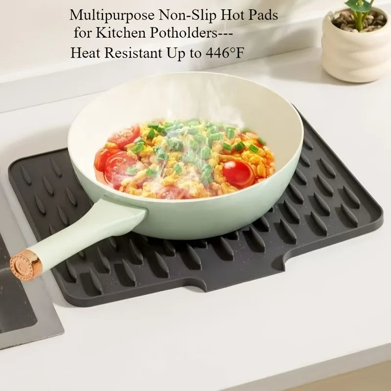 EasyDry Mat on a countertop with a pot, featuring a sloped design and raised silicone ridges for drainage.