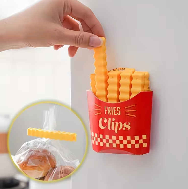 Hand holding a yellow French fry-shaped bag clip, with a container resembling a fry box holding multiple clips.