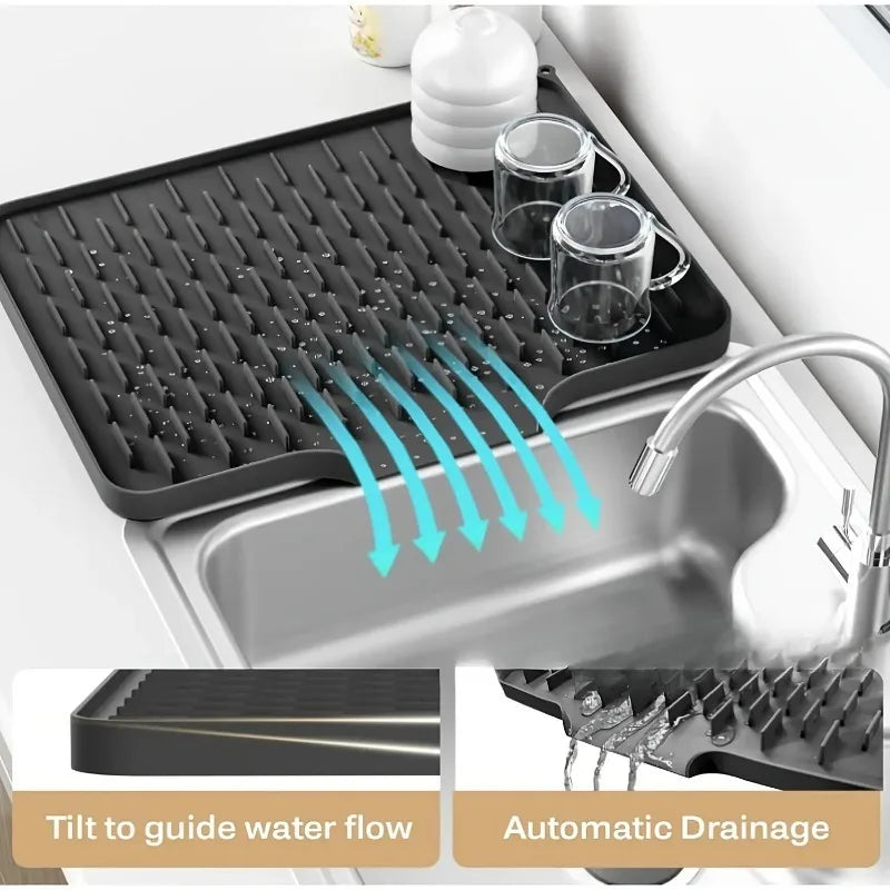EasyDry Mat in a kitchen setting with glasses drying on its sloped design and integrated drainage spout.