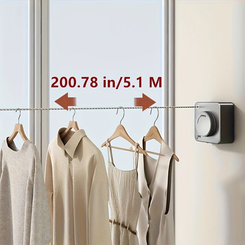 Wall-mounted clothes hanging line with clothing displayed, featuring a retractable design for space-saving laundry solutions.