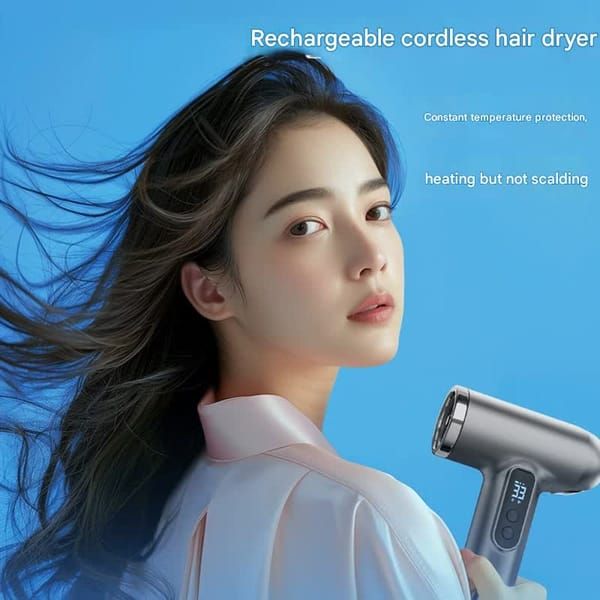 Woman using a sleek cordless hair dryer with a digital display, showcasing its rechargeable feature.