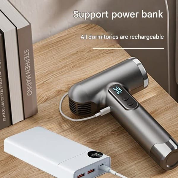 Wireless hair dryer with digital display and power bank in a modern setting with books.