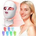 Facial mask in white and pink, featuring LED lights, worn by a smiling individual, showcasing red light therapy for skincare.