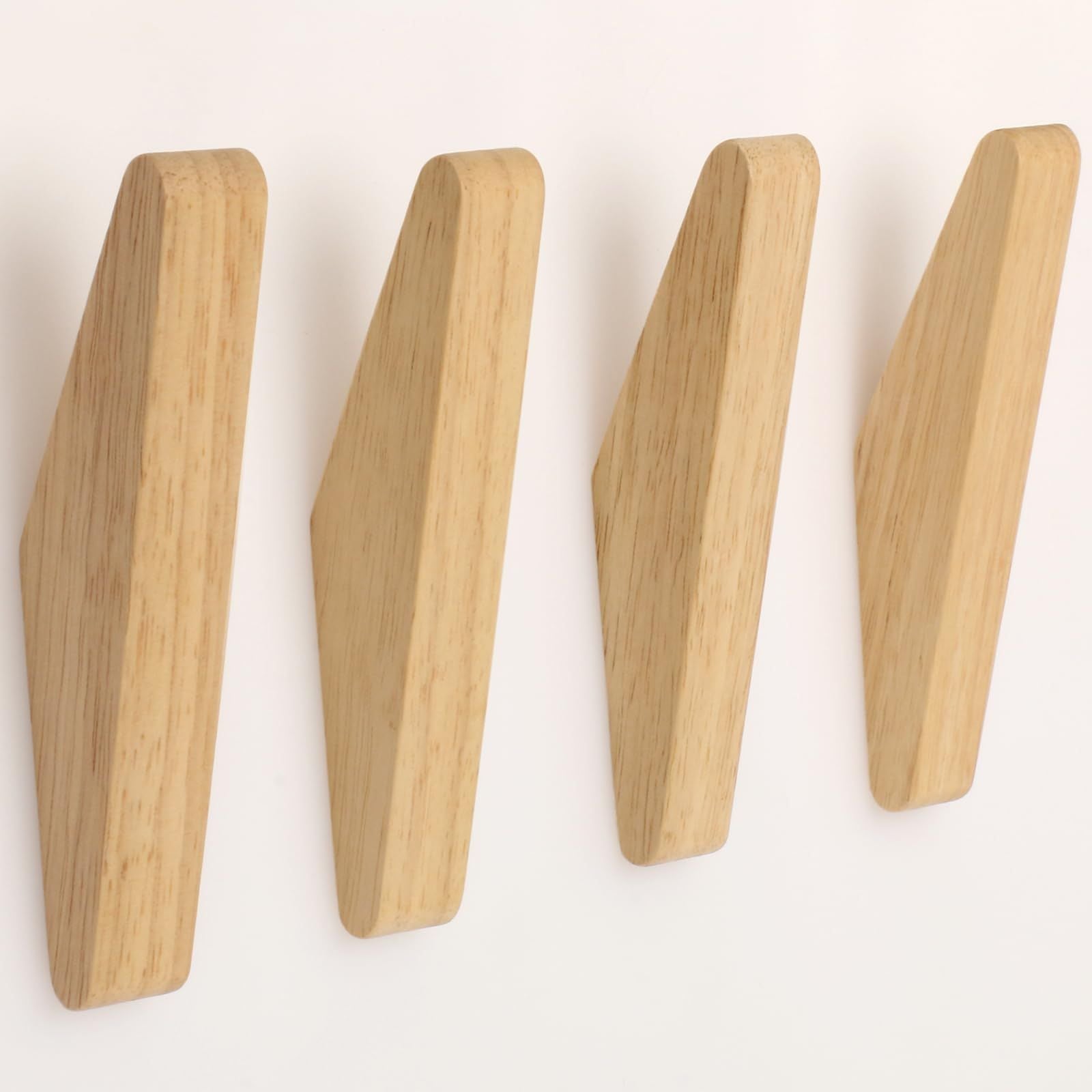 Natural wood wall hooks arranged in a row, showcasing a sleek, modern design for home organization.