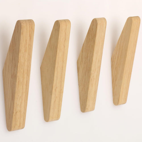 Natural wood wall hooks arranged in a row, showcasing a sleek, modern design for home organization.