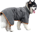 Grey dog bathrobe with orange piping, adjustable strap, and pockets, worn by a dog outdoors.
