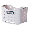 Collapsible laundry basket with ventilation holes and ergonomic handles, featuring a light color and star pattern.